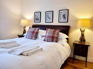 a bedroom with a white bed with pillows and two lamps at Apartment 3 in Darlington