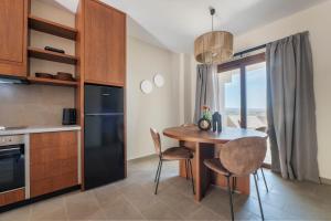 a kitchen with a table and chairs in a room at Casa di Demezzo in Sitia