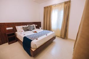 Ein Bett oder Betten in einem Zimmer der Unterkunft Elixir Woods Luxury Resort And Spa, Munnar