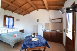 a bedroom with a bed and a table with a sink at Appartamento Comino Faro Sea View in Siniscola