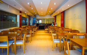 a dining room with wooden tables and chairs at Nuevo Hotel Bristol in Santiago del Estero