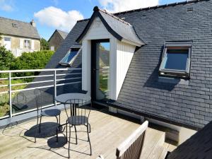 d'un balcon avec une table et des chaises. dans l'établissement A deux pas des îles, à Penvénan