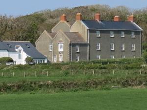 a large house on the side of a hill at Skomer View Solva in Solva