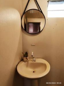 a bathroom with a sink and a mirror at Microcasa com vista para o Cristo in Encantado
