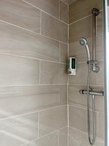 a shower with a shower head in a bathroom at Park Crescent Hotel in Manchester