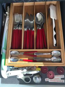 a wooden drawer filled with utensils anduclearuclearuclear at Bella Recanati Apartment a Giardini Naxos in Giardini Naxos