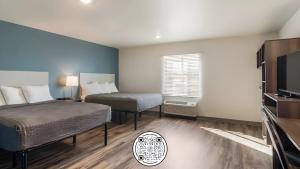 Habitación de hotel con 2 camas y TV en WoodSpring Suites Downers Grove - Chicago en Downers Grove