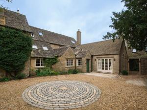 a large brick house with a large labyrinth in the yard at Ashworth House in Leafield