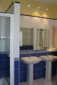 a bathroom with two sinks and a mirror at Résidence Syrina 1 in Trou aux Biches