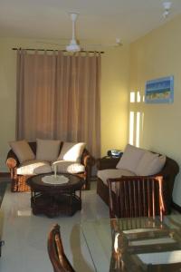 a living room with a couch and a table at Résidence Syrina 1 in Trou aux Biches