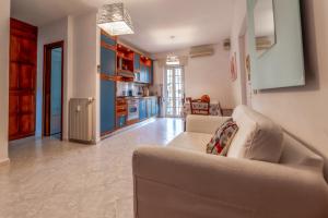 a living room with a couch and a kitchen at Luisa Flat - Metro Basilica San Paolo in Rome