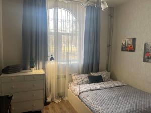 a small bedroom with a bed and a window at Smart in Kharkiv