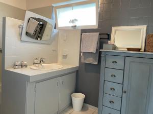 a bathroom with a sink and a mirror at La Fedrie in La Croix-en-Touraine