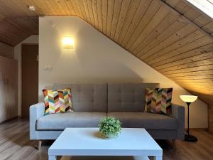 a living room with a couch and a table at Willa Uliaszówka in Szczawnica