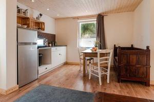 a kitchen with a table and a dining room at Seebär in Ueckeritz