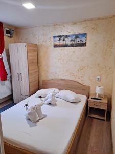 a bedroom with a bed with towels on it at Casa LARA in Constanţa