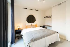 a bedroom with a large white bed in a room at Beautiful 1BR apartment in Antwerp in Antwerp