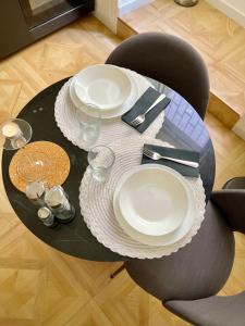 a table with plates and silverware on top of it at Fiorentine Relais in Naples +14 photos