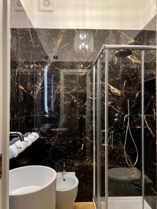 a bathroom with a glass shower and a sink at Fiorentine Relais in Naples +13 photos