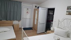 a small bedroom with a bed and a closet at Casa LARA in Constanţa