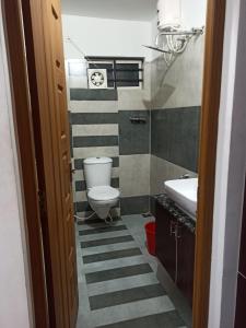 a bathroom with a toilet and a sink at Rieva Residency in Kottayam