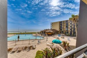a view of the pool and beach from the balcony of a resort at Daytona Beach Resort Studio with Beach Access! in Daytona Beach
