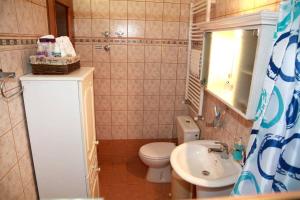 a small bathroom with a toilet and a sink at The StoneHouse in Keramídhion +72 photos