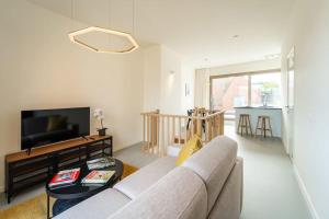 a living room with a couch and a table at Apartments in Antwerp South in Antwerp