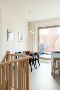 a kitchen and dining room with a table and chairs at Apartments in Antwerp South in Antwerp