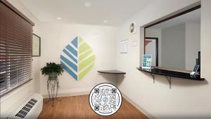 a living room with a mirror on the wall at WoodSpring Suites Lincoln Northeast I-80 in Lincoln