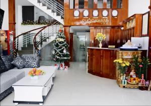 a living room with a christmas tree and a couch at Quốc Khánh Hotel Da Nang in Da Nang