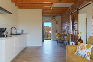 a kitchen and living room with a couch and a table at Casa del Pozo in Santillana del Mar