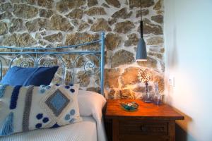 a bedroom with a bed and a table with a lamp at Casa del Pozo in Santillana del Mar