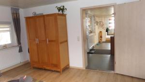 a living room with a wooden cabinet and a hallway at FW & FH Lüsselfeld in Zwiesel +31 photos