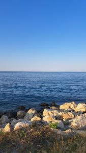 a group of rocks on the shore of a body of water at Casa LARA in Constanţa