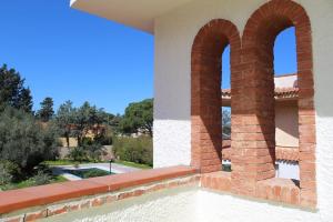 a view from the balcony of a house with two arches at Don Ciccio Sea House in Carini