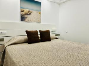מיטה או מיטות בחדר ב-Apartamento del Sol Rosa