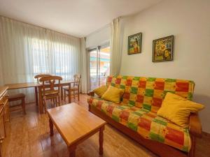 a living room with a couch and a table at Apartamentos Portofino 3000 in Oropesa del Mar