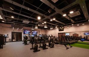 a gym with rows of treadmills and cardio equipment at Cameron House - Lodge 17 - Loch Lomond in Balloch