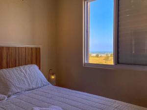 a bedroom with a bed and a large window at Resid. Clube Mar Grosso - Laguna - LAG605 in Laguna +39 photos