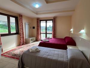 a bedroom with two beds and a window at Residenza Domus Aurea Tropea- Vista Mare in Tropea