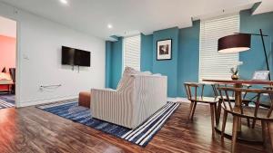 a living room with a table and a dining room at The Lofts on Clematis 405 Downtown West Palm Beach in West Palm Beach