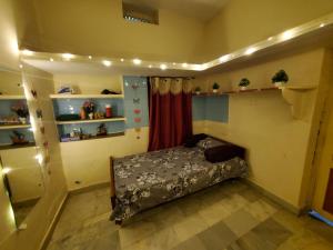 a bedroom with a bed in a room with lights at Entire 2bhk ground-floor suite in independent house in Secunderabad