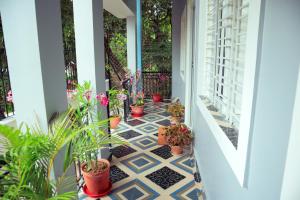 a porch with potted plants on it at Ichhepuron (My Home) in Shānti Niketan +15 photos
