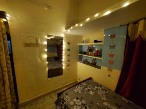 a small room with a bed and a mirror at Entire 2bhk ground-floor suite in independent house in Secunderabad