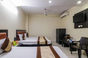 a hotel room with two beds and a tv at Hotel Preet - Family Hotel in New Delhi