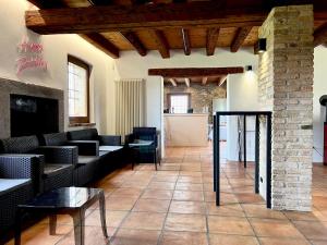 a living room with couches and tables and a fireplace at Villa Saten in Pavia dʼUdine +52 photos