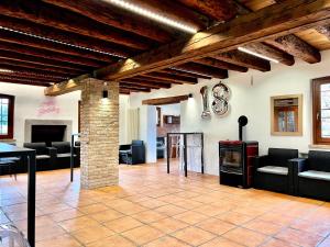a living room with couches and a fireplace at Villa Saten in Pavia dʼUdine