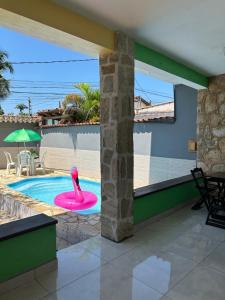 a swimming pool with a pink swan in a house at Pousada Brisa de Paraty ll in Paraty