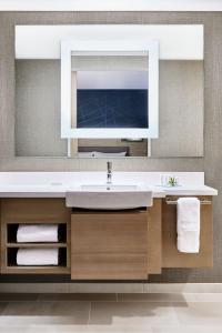 a bathroom with a sink and a large mirror at SpringHill Suites by Marriott Tampa Downtown in Tampa
